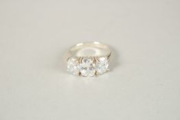 A SILVER AND THREE STONE CZ RING. Ring size (P).