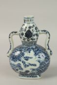 A CHINESE BLUE AND WHITE DRAGON DOUBLE GOURD MOONFLASK. 23.5cms high.
