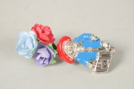 A SILVER PADDINGTON'S ENAMEL FLOWER POSY PIN.