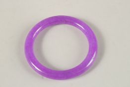 A LAVENDER JADE BANGLE. 7.5cms diameter.