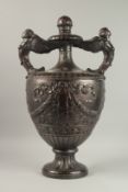 A GOOD LARGE GEORGE III STYLE MAHOGANY TWO HANDLED URN with winged handles, ribbons and garland