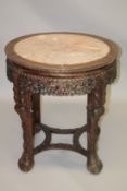 A CHINESE CARVED HARDWOOD AND MARBLE TOP CIRCULAR URN STAND, 19TH CENTURY, with inset pink marble