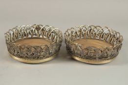 A SUPERB PAIR OF WILLIAM IV SILVER WIREWORK AND GRAPEVINE WINE COASTERS, 15cms diameter, with turned