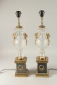 A PAIR OF HOBNAIL CUT GLASS AND GILT METAL TWO HANDLED LAMPS on pedestal bases. 64cms high.