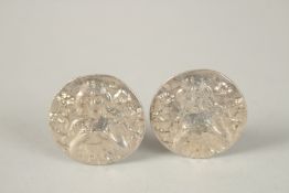 A PAIR OF SILVER REPLICA COIN CUFFLINKS.