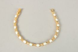 AN 18CT GOLD PLATED OPAL SET LINE BRACELET.