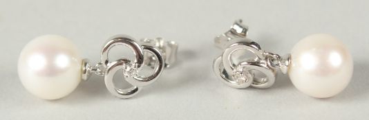 A PAIR OF 9CT WHITE GOLD ROUND FRESHWATER PEARL AND DIAMOND PIN WHEEL EARRINGS. Diamonds 0.05ct.