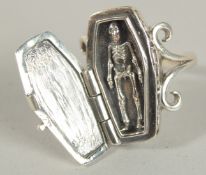 A SILVER COFFIN AND SKELETON RING.