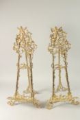 A PAIR OF GILT METAL EASELS. 62cms high.