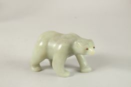 A LARGE RUSSIAN CARVED JADE POLAR BEAR with ruby eyes. 13cms long x 7cms high, in a Faberge box.