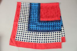 AN YVES SAINT LAURENT RED, WHITE AND BLUE POLKA DOT SILK SCARF. 90cms x 90cms.