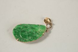 A CHINESE GOLD BACKED PENDANT. 3cms.