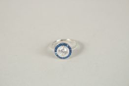 A SILVER FAUX SAPPHIRE AND CZ RING. Ring size (K+).
