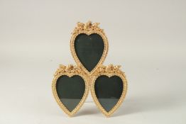 A GILT BRONZE TRIPLE HEART SHAPED PHOTOGRAPH FRAME. 33cms high.