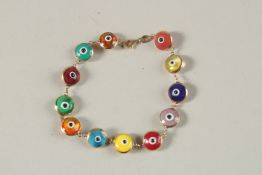 A 14CT GOLD BRACELET, set with twelve coloured glass beads in the form of eyes.