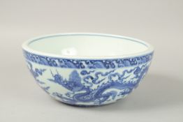 A CHINESE BLUE AND WHITE PORCELAIN DRAGON BOWL. 25.5cms diameter.