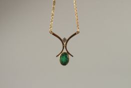 AN 18CT YELLOW GOLD, DIAMOND AND EMERALD PENDANT with 18ct yellow gold chain.