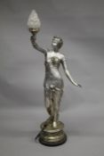 A LARGE SILVER PAINTED BRONZE FLOOR STANDING LAMP MODELLED AS A FEMALE FIGURE holding a flaming