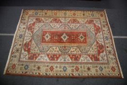 A TURKISH MILAS TABAN CARPET red ground with stylised decoration. 12ft 6ins x 9ft 10ins.