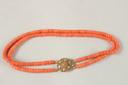 A DOUBLE ROW CORAL NECKLACE with 18CT GOLD CLASP. Each row 20cms long.