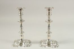 A PAIR OF GEORGE II CAST SILVER CANDLESTICKS. Sheffield 1825. Maker W. B. & B. 22cms high. Weight