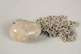 A HERMES JADE EGG PENDANT on a silver chain, stamped HERMES, PARIS.