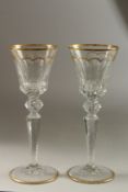 A GOOD LARGE PAIR OF ST. LOUIS GILDED TALL GLASSES. 25cm high.