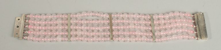 A SILVER AND ROSE QUARTZ FIVE ROW BRACELET.