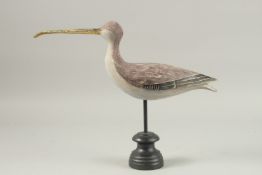 A PAINTED WOODEN CURLEW on a wooden stand.