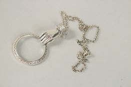A SILVER HAND RUBY SET MAGNIFYING LOUPE.