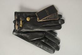 A PAIR OF NEW TED BAKER LADIES BLACK LEATHER GLOVES. Size M/L. Boxed.