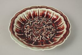 A CHINESE FLAMBE PETAL-FORM DRAGON DISH. 28cms wide.