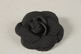 A CHANEL BLACK FABRIC ROSE.