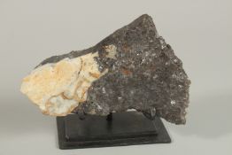 A MINERAL SPECIMEN. 17cm long on a stand.