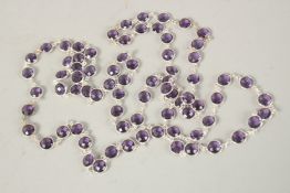 A LONG SILVER AMETHYST GUARD CHAIN. 114cms long.
