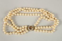 A GOOD THREE ROW PEARL NECKLACE with 9CT GOLD CLASP.