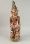 A LARGE CARVED WOODEN AND PAINTED FEMALE FIGURE with three children. 90cm high.