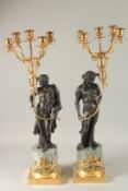 A GOOD PAIR OF THOMAS HOPE DESIGN BRONZE AND GILT METAL FIVE LIGHT CANDELABRA with classical figures