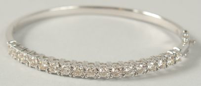 A 9CT WHITE GOLD HINGED BANGLE SET WITH 2.21 RBC DIAMONDS, with double safety catch.