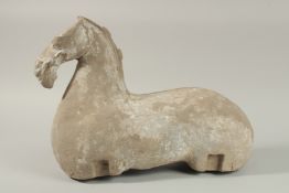 A LARGE HAN DYNASTY CARVED STONE HORSE, 44cm long.