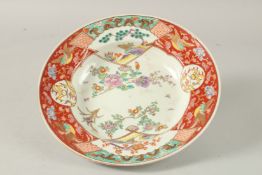 A JAPANESE PORCELAIN DISH, enamel painted with flora, birds, and dragon motifs, the base with six-