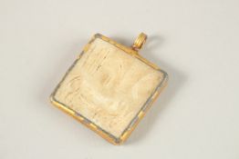 AN EARLY CARVED STONE SEAL PENDANT.