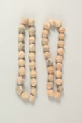 TWO CARVED TERRACOTTA BEADED NECKLACES.