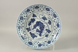 A CHINESE BLUE AND WHITE PORCELAIN CHARGER, painted with a central panel of grapes and border of