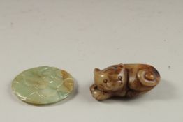 A FINELY CARVED CHINESE JADE ROUNDEL - POSSIBLY CHING DYNSATY, and another carved jade dog, (2)
