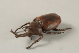 A BRONZE OKIMONO OF A RHINO BEETLE, with articulated wings.