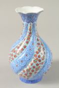 A PERSIAN ENAMELLED VASE, with lobed body painted with floral motifs, base signed, 18.5cm high.