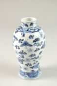 A CHINESE BLUE AND WHITE PORCELAIN VASE, painted with butterflies and flowers, the base with four-