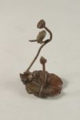 A BRONZE OKIMONO OF A BIRD ON A LOTUS.