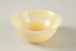 A CHINESE CARVED JADE BOWL, 12cm diameter.